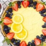 vegan lemon tart with lemons and fresh berries