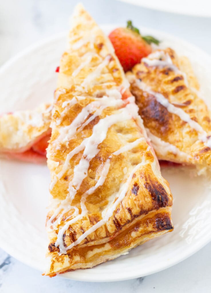 Strawberry hand pies, cut in half, and topped with a sugar drizzle