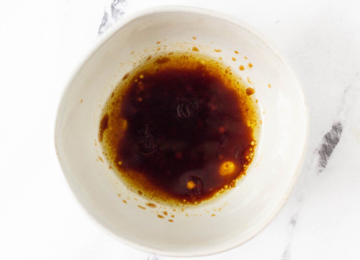 Oil and soy sauce mixed together in small bowl.
