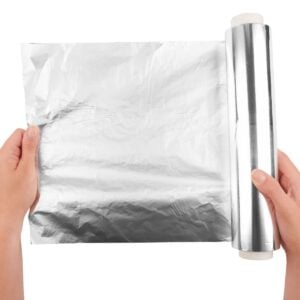hands pulling aluminum foil