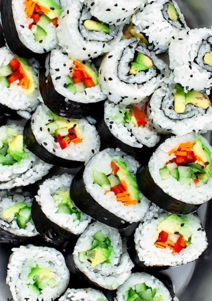assorted vegetable sushi rolls with avocado, carrots, cucumbers, red pepper