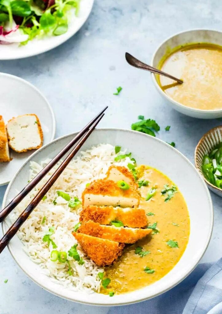 tofu katsu curry in coconut sauce served with rice in wide bowl
