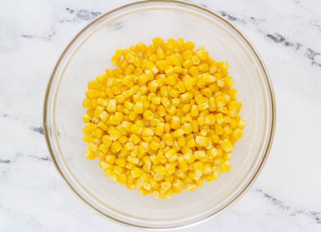 defrosted frozen corn in glass bowl