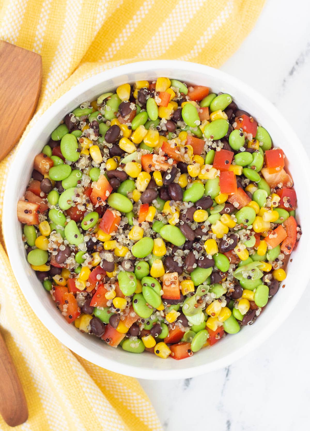 black bean edamame salad in white serving bowl