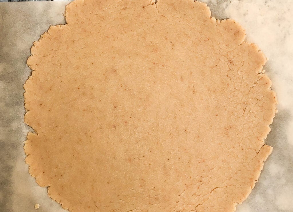 pie crust rolled out onto parchment paper