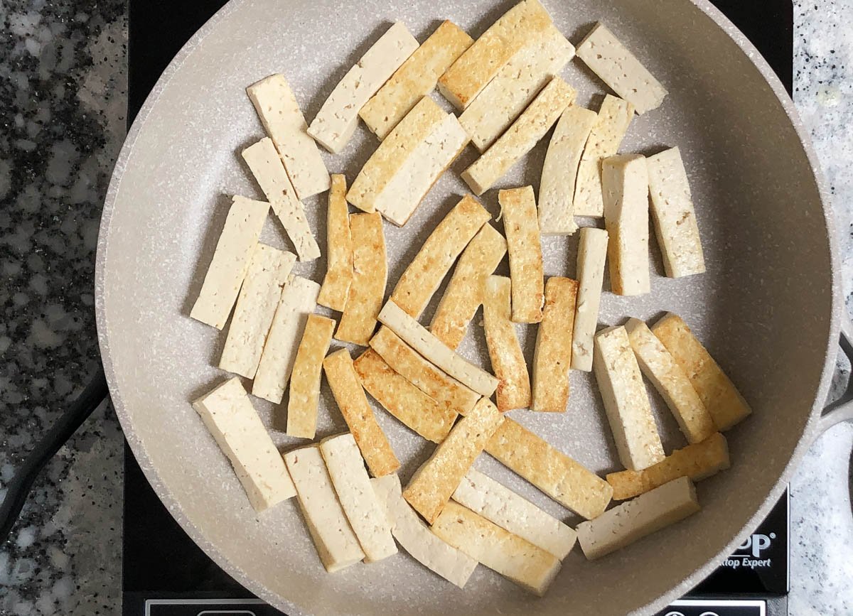 Tofu strips in skillet.