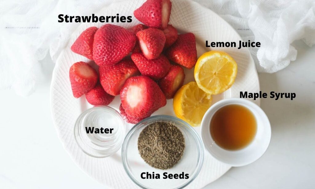 Plate with strawberries, water, ground chia, maple syrup, and sliced lemon