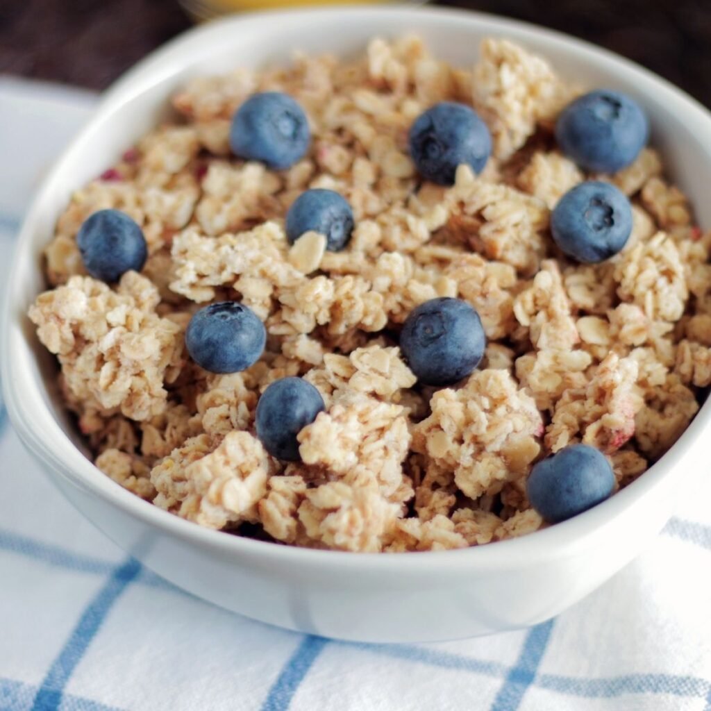 bowl of granola topped blueberries