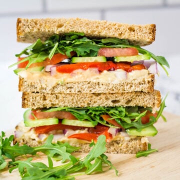 copycak Panera mediterranean veggie sandwich cut in half with two halves stacked on top of one another
