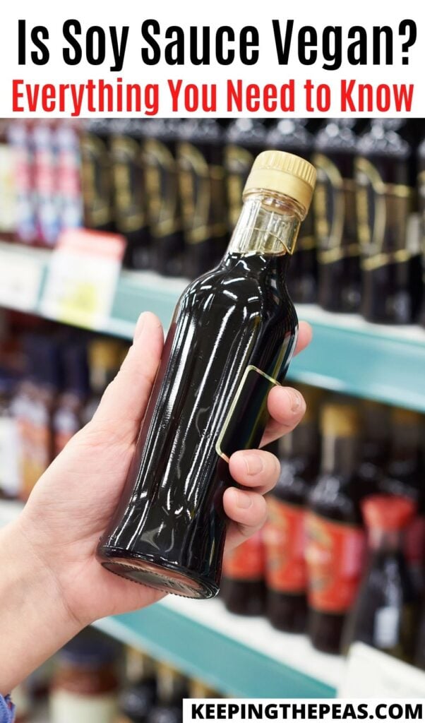 hand holding bottle of soy sauce in grocery store