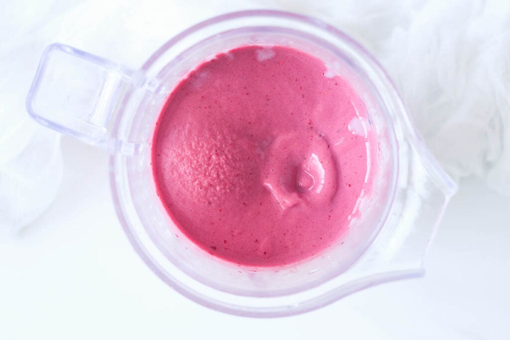 overhead of blended berry smoothie in blender