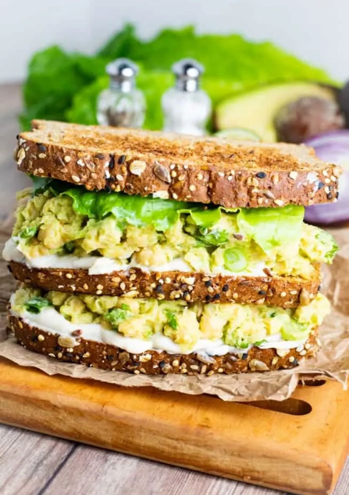 avocado chickpea salad sandwich served on whole grain bread