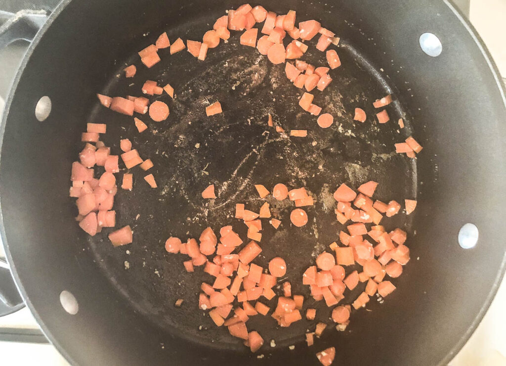 diced carrots on the bottom of a pot