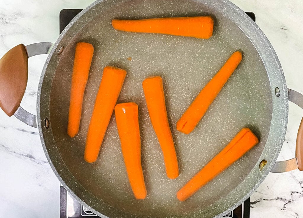 Carrots boiling in pot.