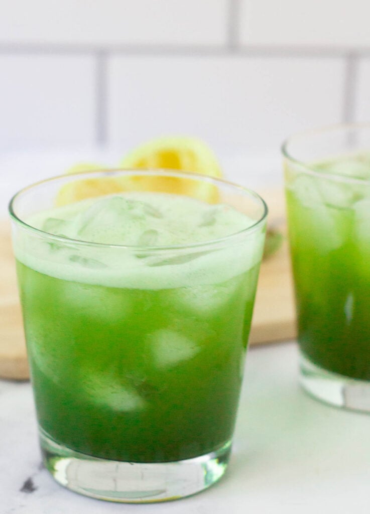 Green tea lemonade in glass with ice.