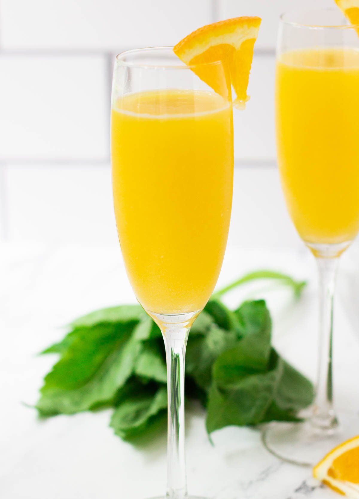 Champagne flute filled with a mimosa mocktail. 