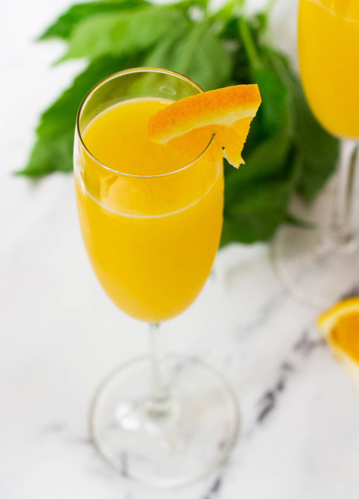 Top down view of a mimosa mocktail in a champagne flute.