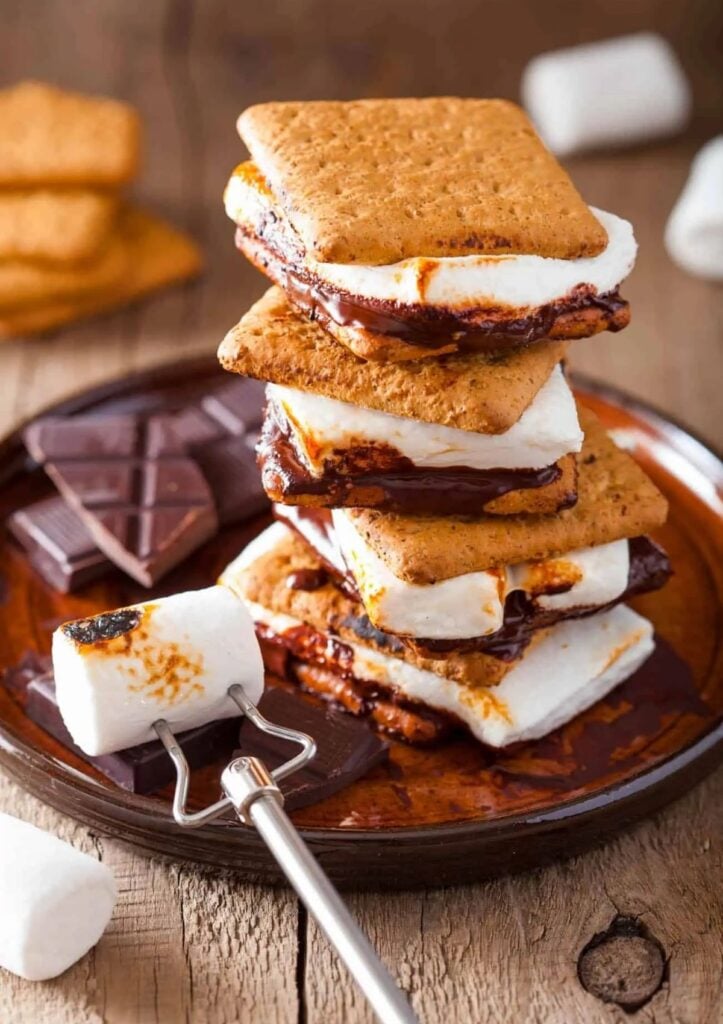 Stack of s'mores on brown plate.