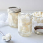 Cubed Korean pickled radishes in mason jars.