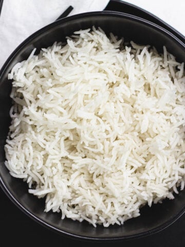 White rice in black bowl.