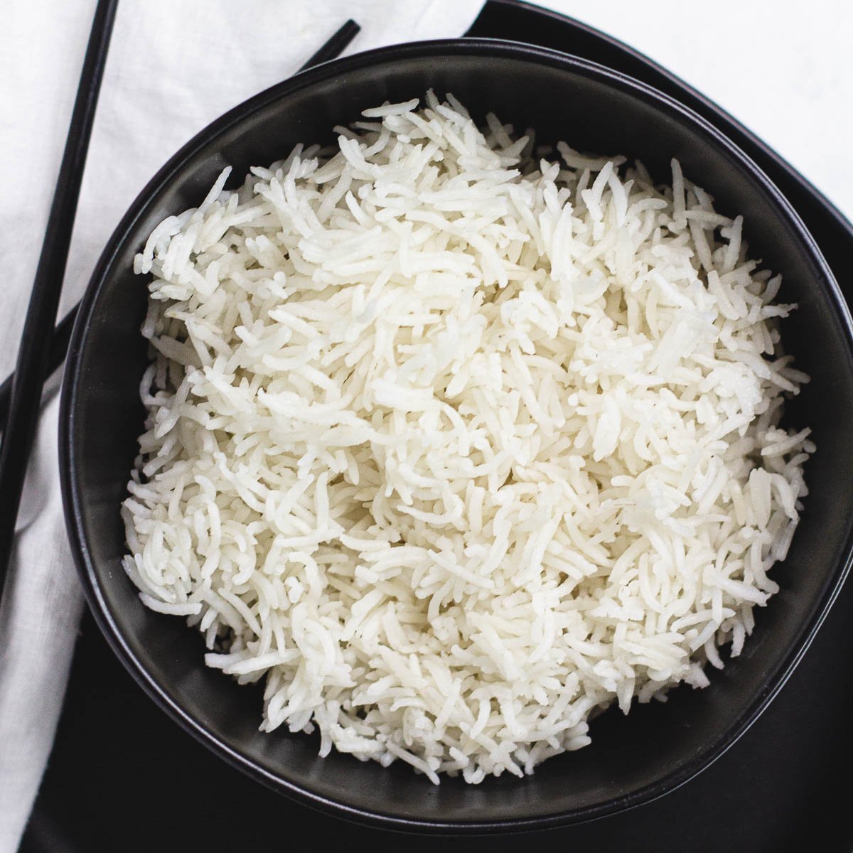 White rice in black bowl.