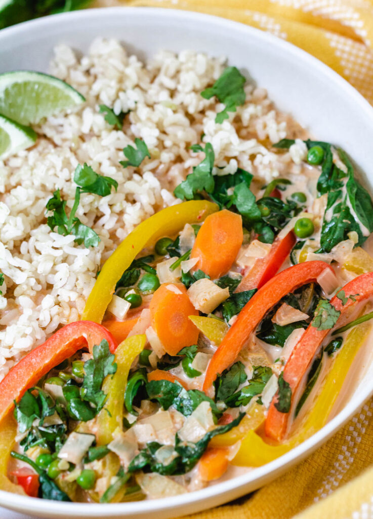 Carrots, peppers, spinach, and peas, in a red curry sauce, served with rice.