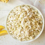 Air fryer popcorn in white bowl.