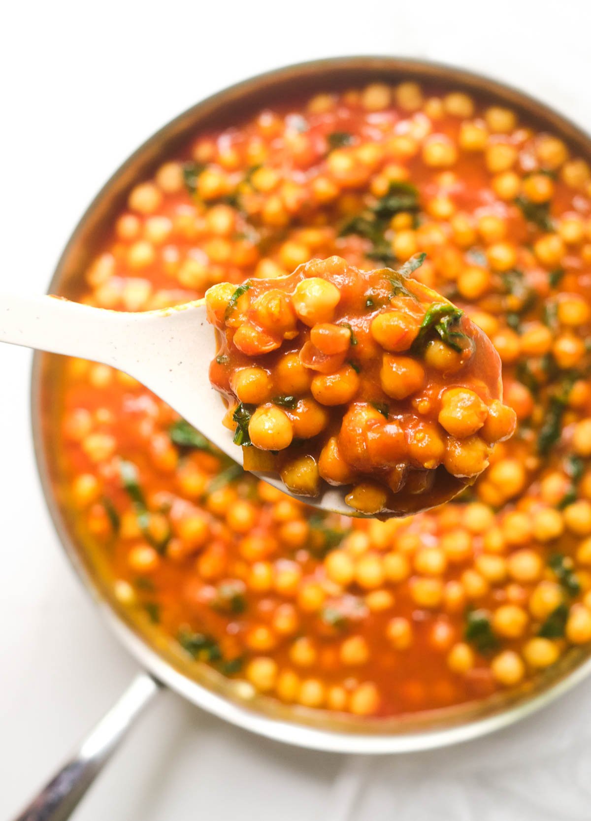 Chickpea and spinach curry in saute pan.