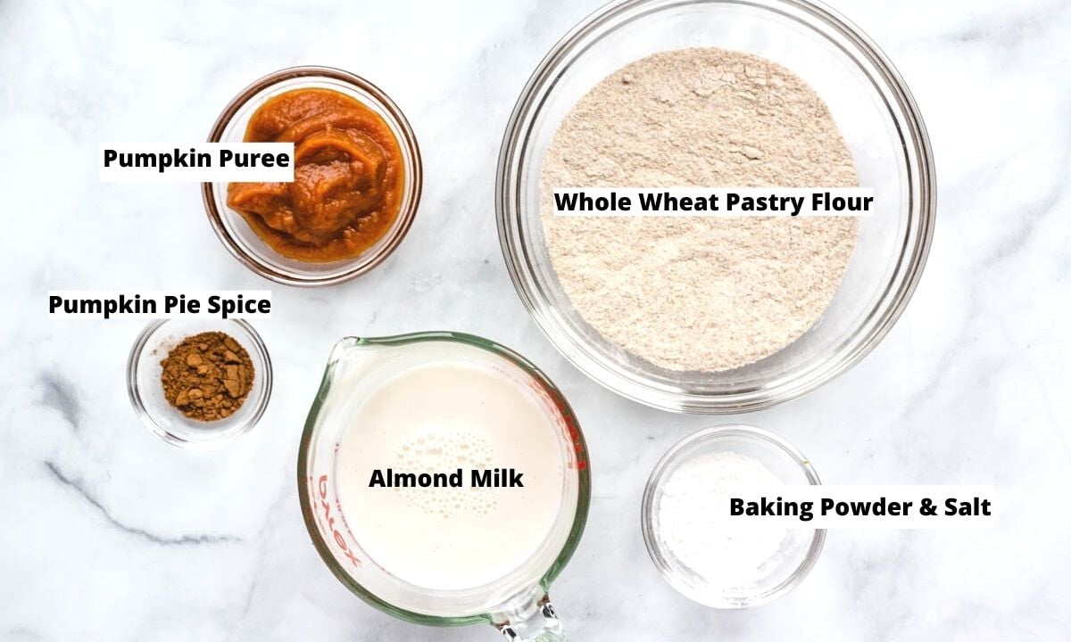 Pumpkin pancake ingredients: pumpkin puree, whole wheat pastry flour, pumpkin pie spice, almond milk, baking powder, and salt. 