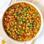 Punjabi chole with chickpeas in wide white bowl.
