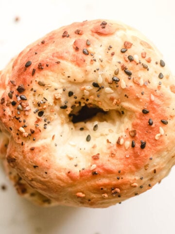 Vegan bagel topped with sesame seeds and poppy seeds.