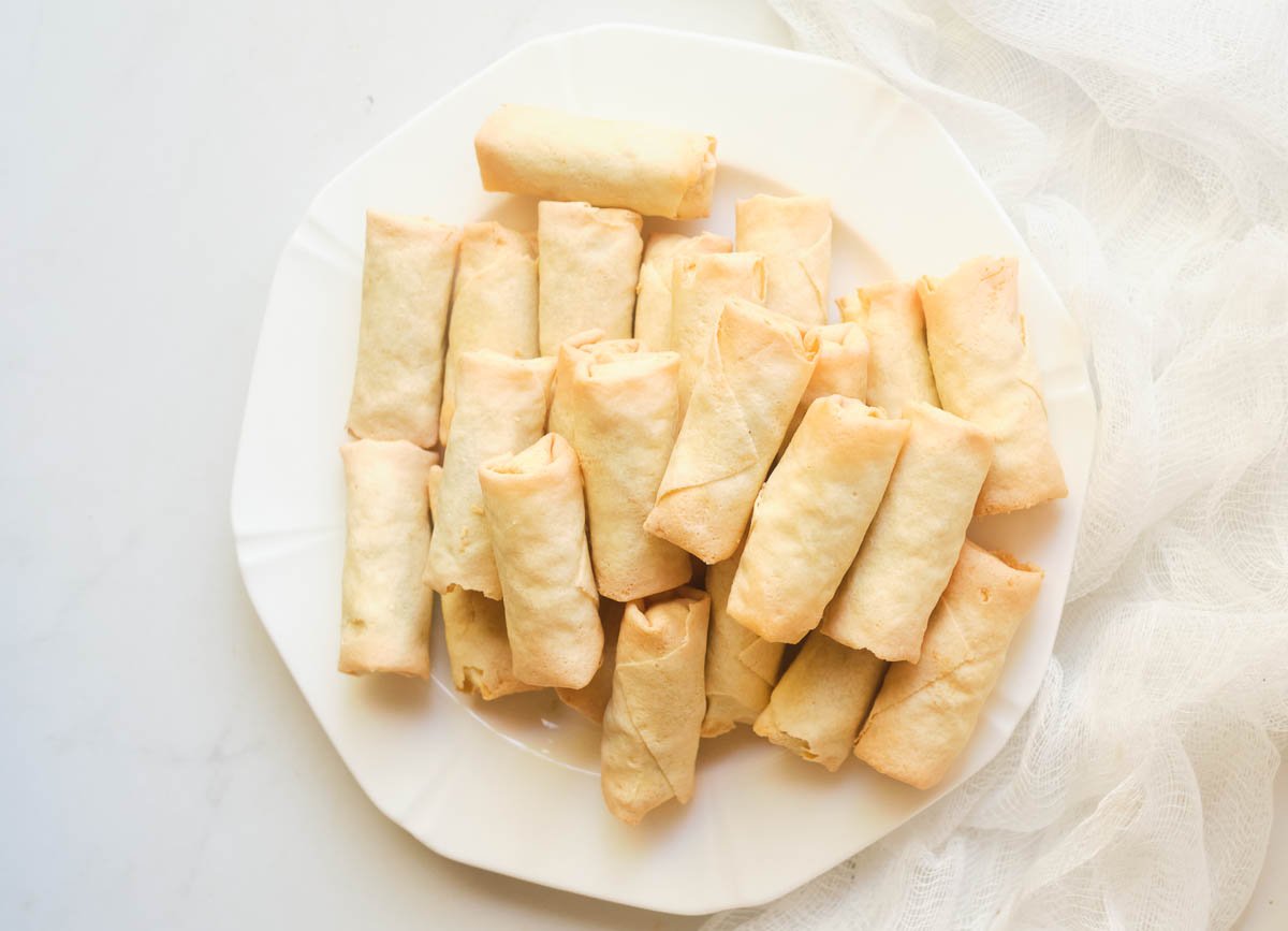 Frozen spring rolls on a white plate.