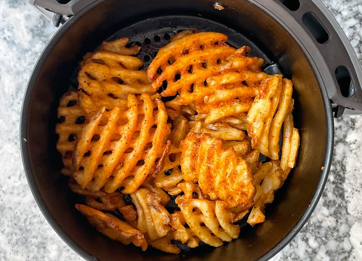 Crispy cooked waffle fries in air fryer.
