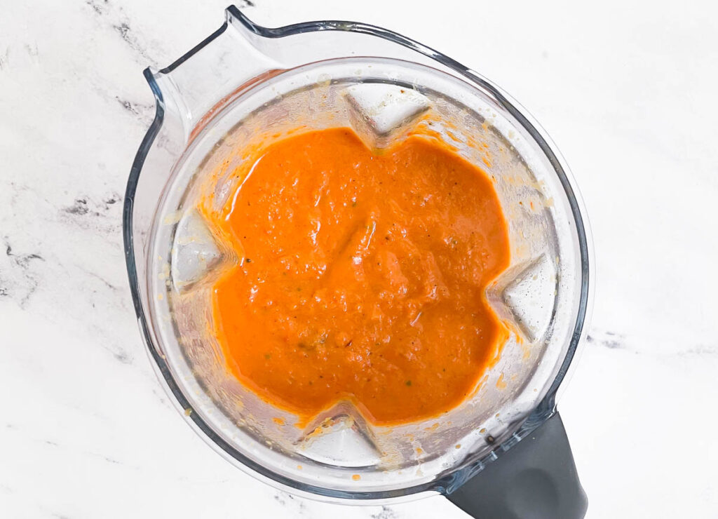 Pureed butternut squash and red pepper soup in blender. 