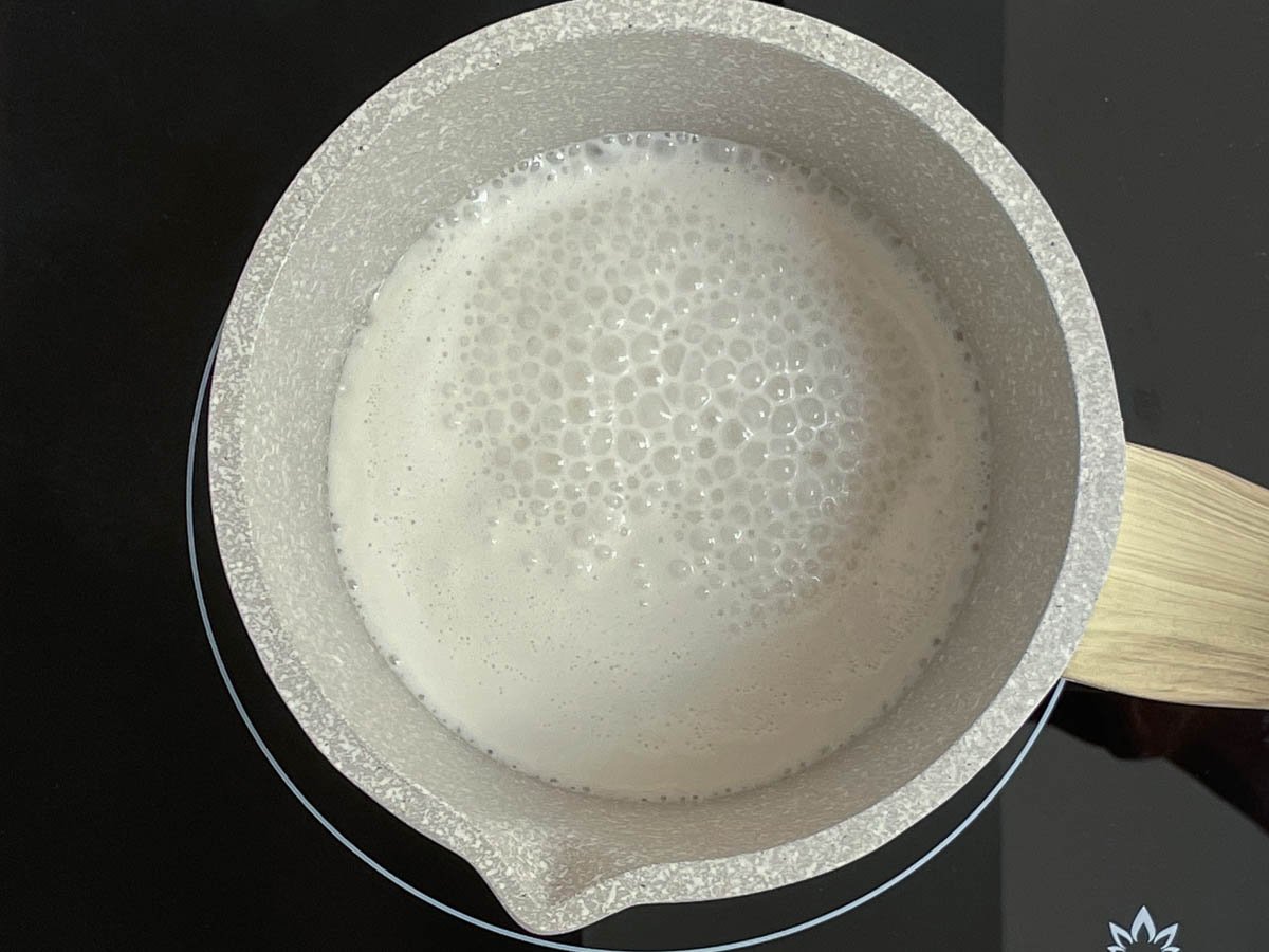Coconut milk in saucepan.