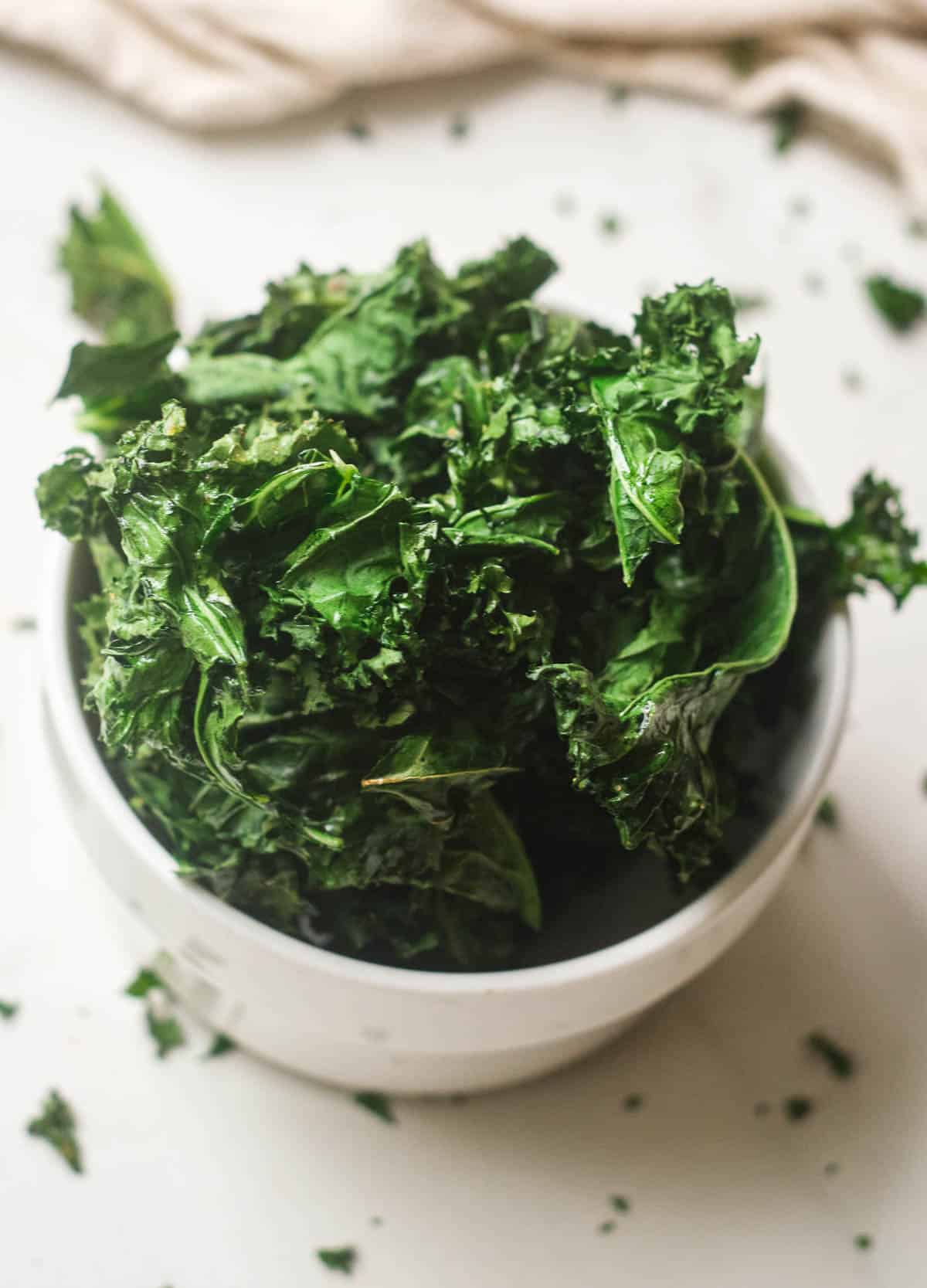 Kale chips in white bowl.