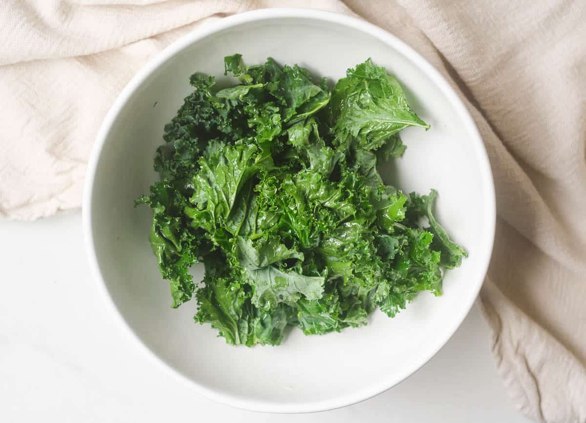 Kale leaves massaged with oil, salt, and garlic powder.