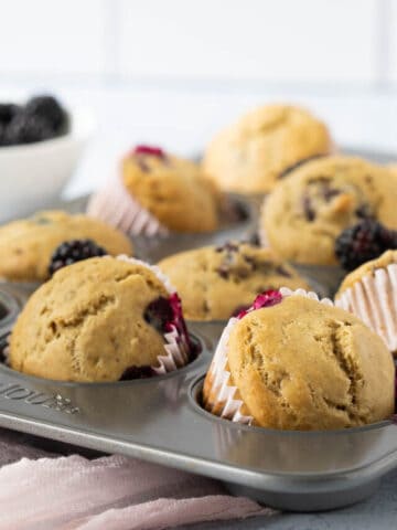 Vegan blackberry muffins in muffin tin.