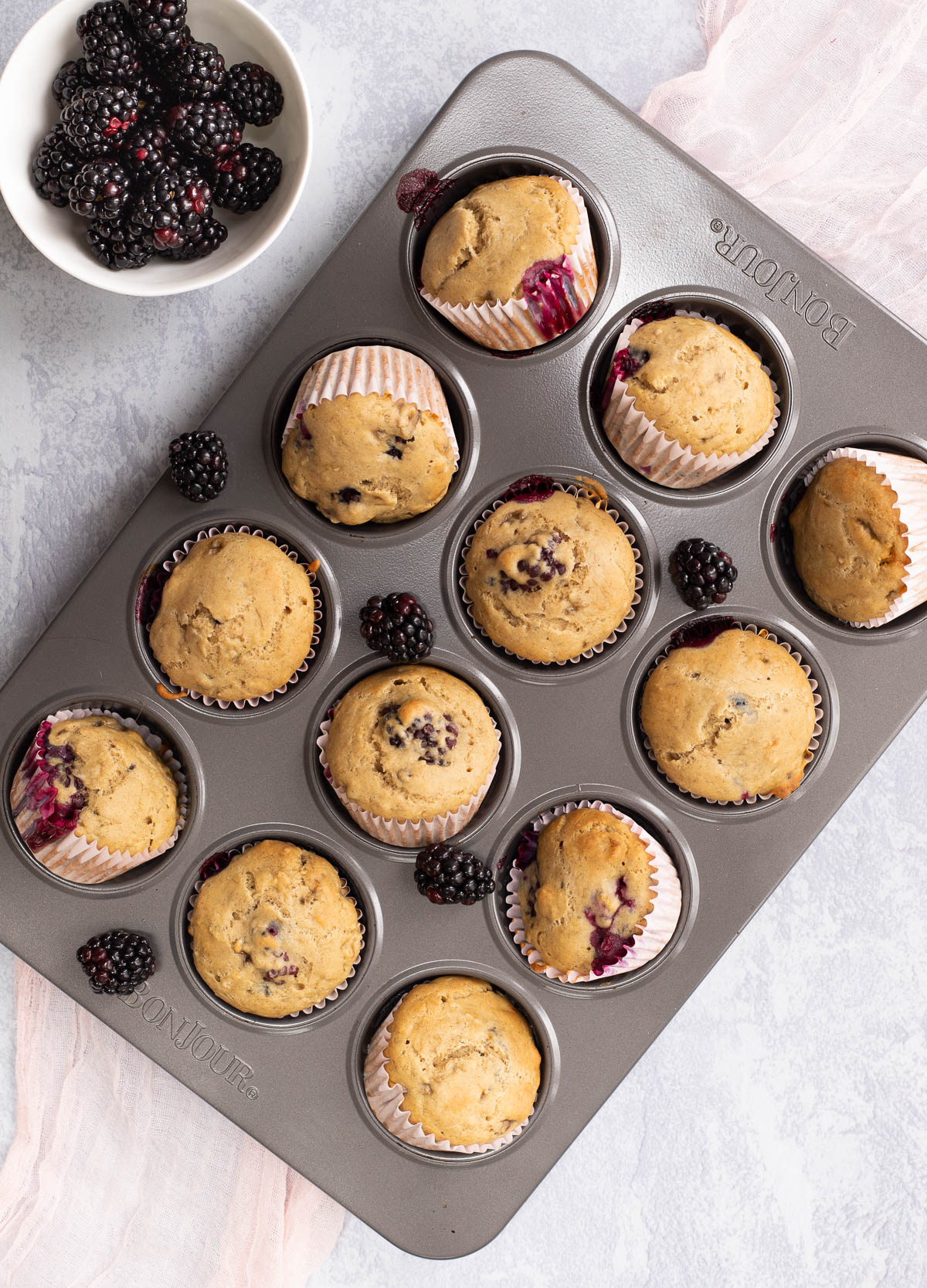 Vegan blackberry muffins in muffin tin.