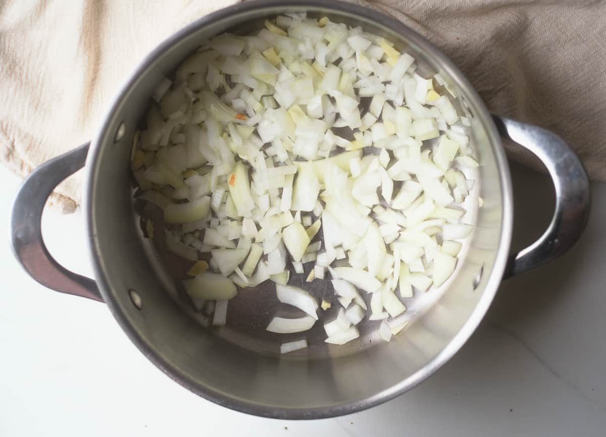 Diced onions and garlic in a saute pan.