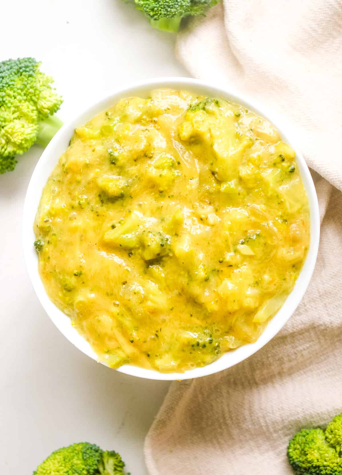 Vegan broccoli cheddar soup in white bowl. 