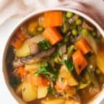 Vegan vegetable stew in white bowl.