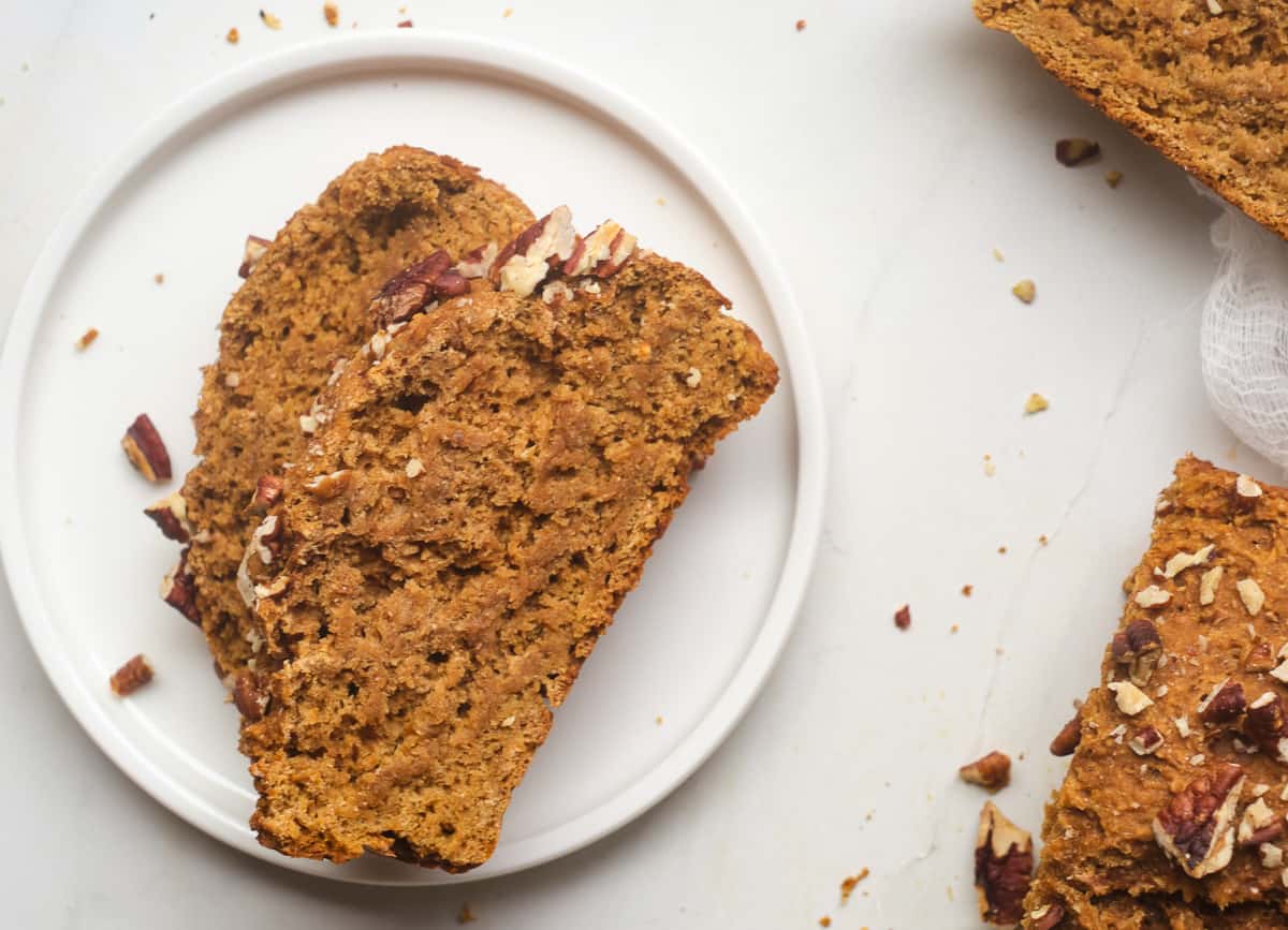 Slice of gingerbread loaf on a plate.