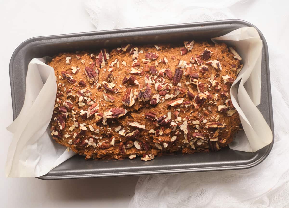 Baked vegan gingerbread loaf in loaf pan.