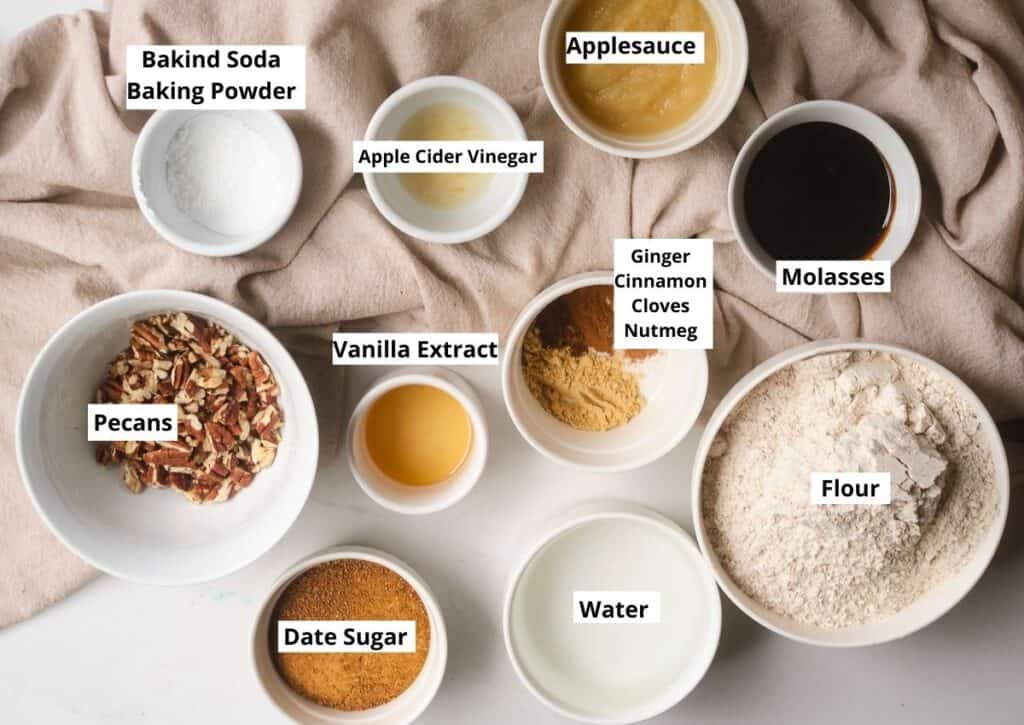 Ingredients for Vegan Gingerbread Loaf: baking soda, baking powder, apple cider vinegar, applesauce, molasses, flour, water, date sugar, vanilla extract, and spices. 