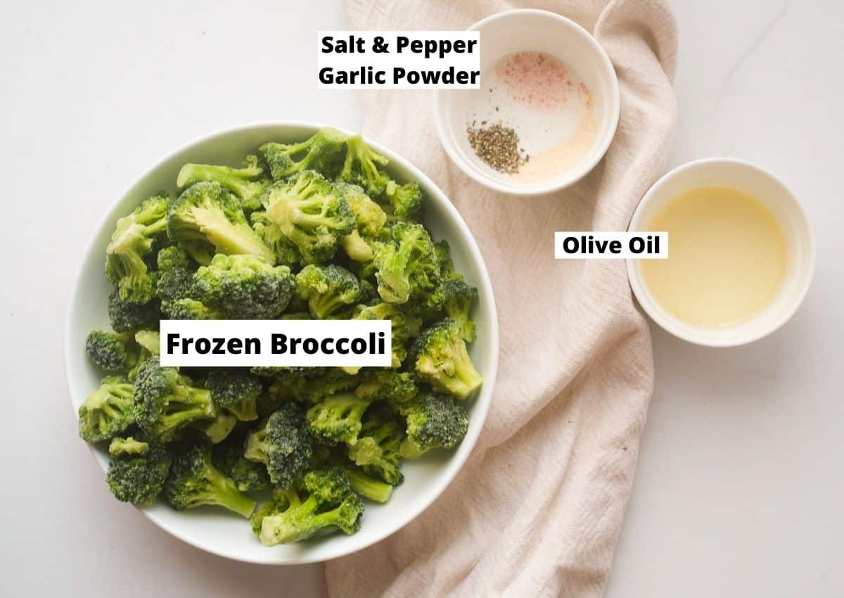 Frozen broccoli florets, olive oil, and spices in bowls. 