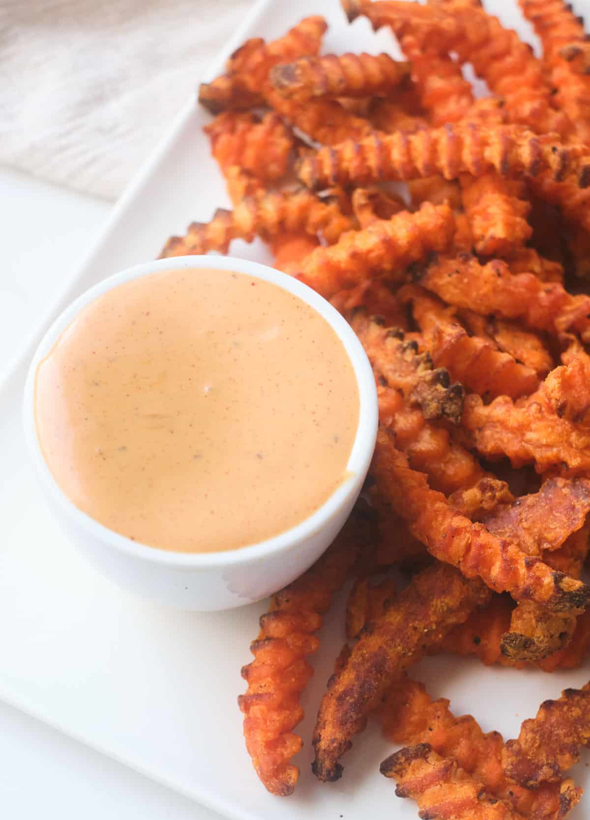 Sweet potato fries served with a creamy dipping sauce.