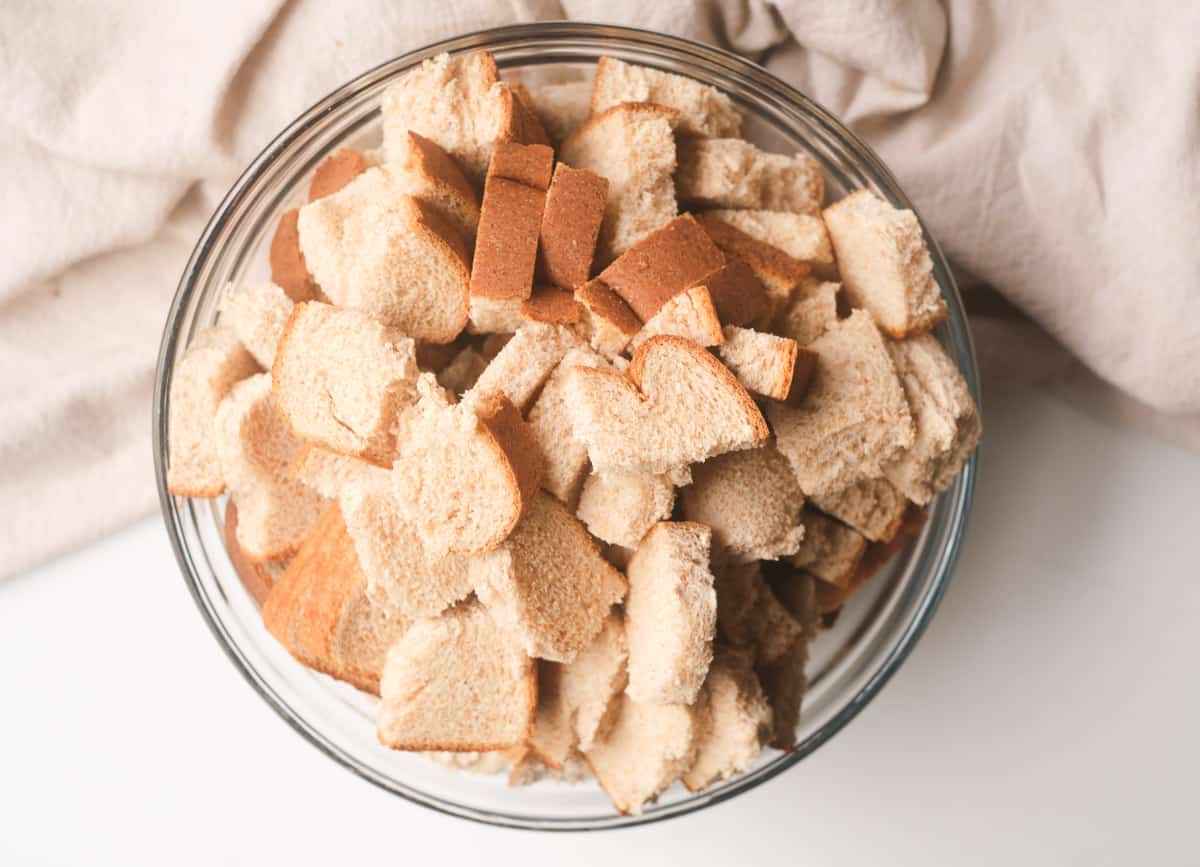 Bread pieces cut into one inch squares in bowl. 