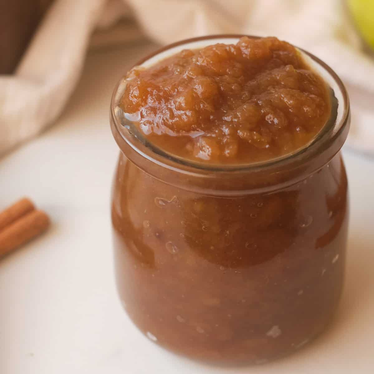 Instant pot apple butter in small glass jar.