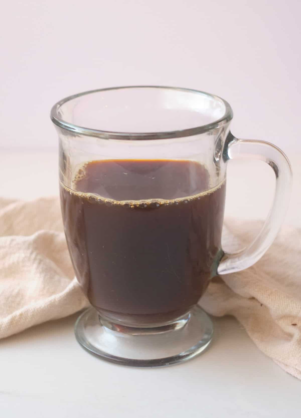 Black coffee in glass mug.